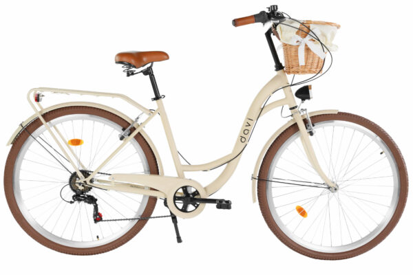 Krämfärgad cykel med korg och bruna däck